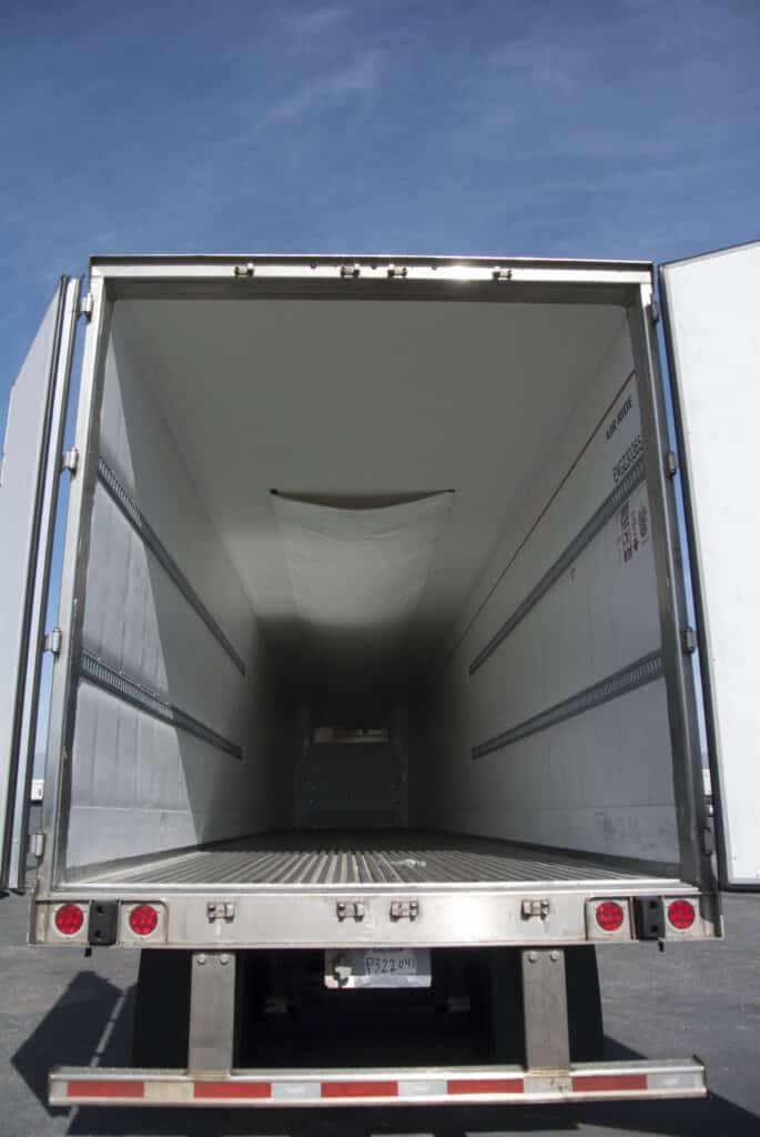 A C.R. England trailer, open for freight.